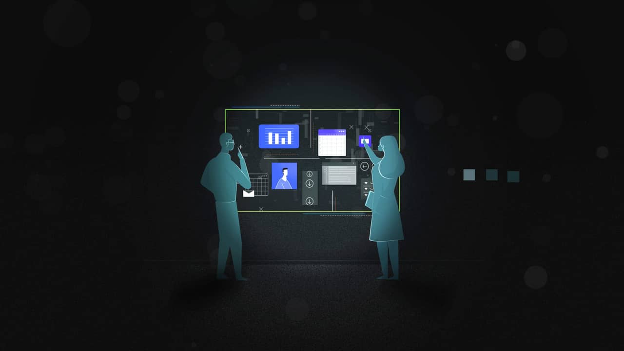 Interface in context — two figures working a lit data wall